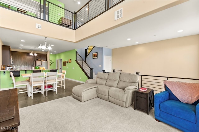 3159 Via Como, Henderson, NV 89044 - living room featuring a chandelier, a towering ceiling, recessed lighting, stairway, and tile patterned floors
