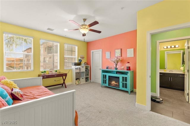 3159 Via Como, Henderson, NV 89044 - bedroom with multiple windows, light colored carpet, and a warm lit fireplace