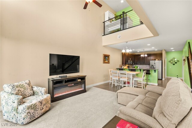 3159 Via Como, Henderson, NV 89044 - carpeted living area featuring baseboards, recessed lighting, a chandelier, ceiling fan, and a high ceiling