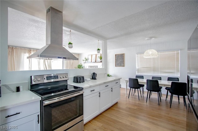 6301 Garwood Ave, Las Vegas, NV 89107 - kitchen featuring electric stove, island range hood, a textured ceiling, white cabinetry, and light wood finished floors