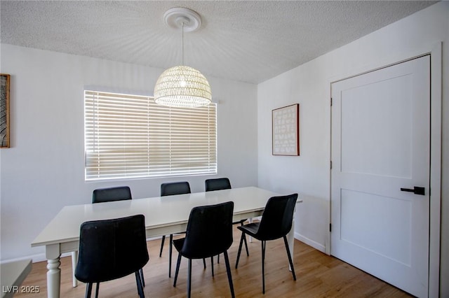 6301 Garwood Ave, Las Vegas, NV 89107 - dining space featuring light wood-type flooring and a textured ceiling