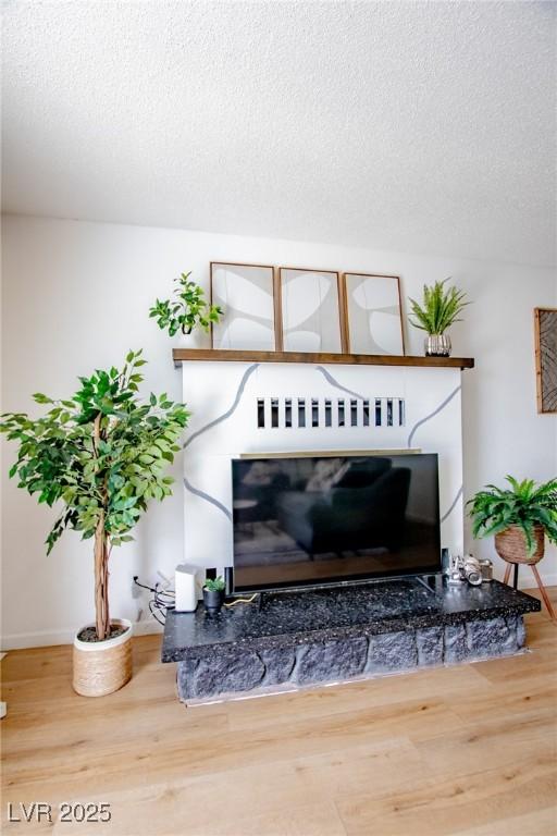 6301 Garwood Ave, Las Vegas, NV 89107 - detailed view of a textured ceiling, wood finished floors, and baseboards