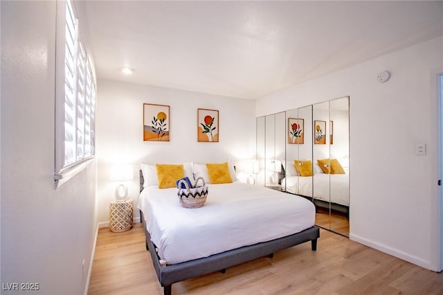 6301 Garwood Ave, Las Vegas, NV 89107 - bedroom featuring baseboards, light wood-style flooring, and a closet