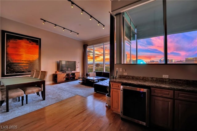 360 E Desert Inn Rd Unit 1803, Las Vegas, NV 89109 - living room featuring beverage cooler, wood finished floors, bar area, and track lighting