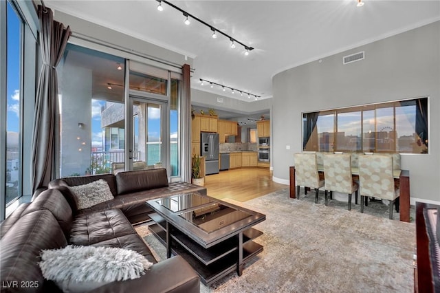360 E Desert Inn Rd Unit 1803, Las Vegas, NV 89109 - living room featuring track lighting, baseboards, and light wood finished floors