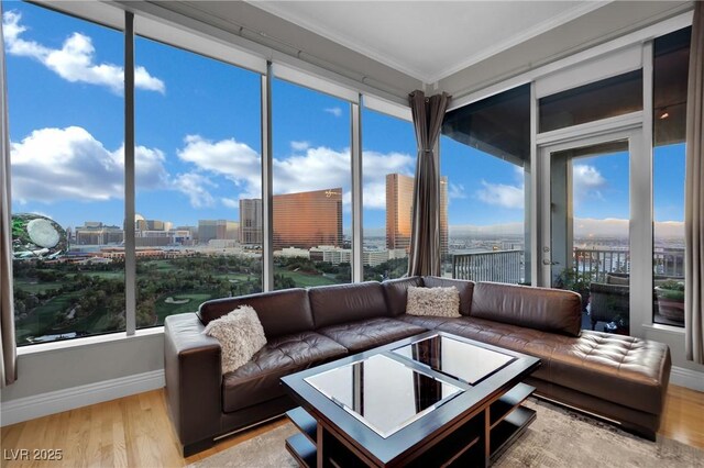360 E Desert Inn Rd Unit 1803, Las Vegas, NV 89109 - sunroom / solarium with wood finished floors, crown molding, baseboards, and a view of city