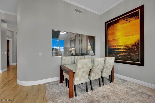 360 E Desert Inn Rd Unit 1803, Las Vegas, NV 89109 - dining space featuring crown molding, baseboards, and wood finished floors