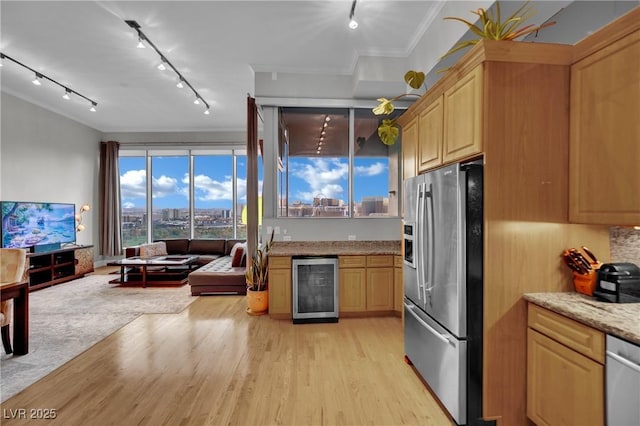 360 E Desert Inn Rd Unit 1803, Las Vegas, NV 89109 - kitchen featuring appliances with stainless steel finishes, beverage cooler, rail lighting, crown molding, and open floor plan