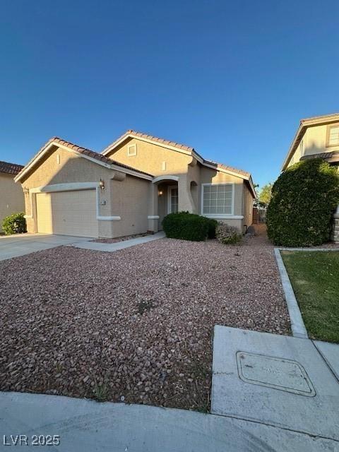 3416 Mountain Park St, Las Vegas, NV 89129 - view of front of house featuring an attached garage, stucco siding, a tile roof, and driveway