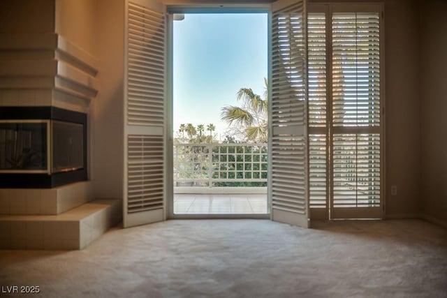 2104 Inverness Dr, Henderson, NV 89074 - unfurnished living room with carpet floors and a tiled fireplace