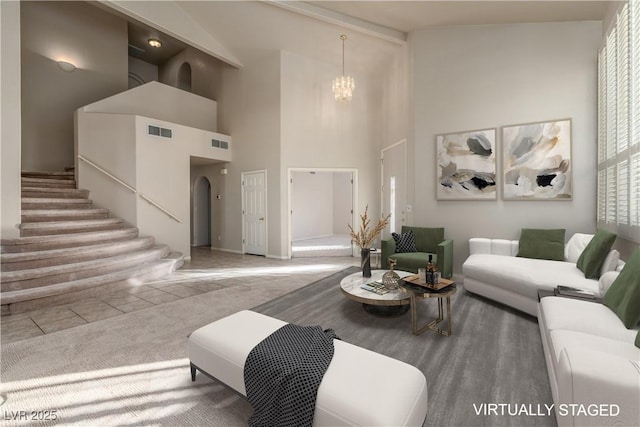2104 Inverness Dr, Henderson, NV 89074 - living area featuring a chandelier, high vaulted ceiling, stairs, and arched walkways