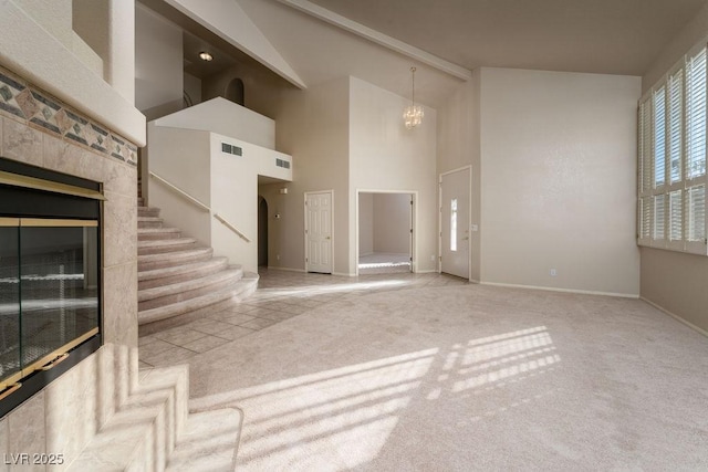 2104 Inverness Dr, Henderson, NV 89074 - unfurnished living room featuring a chandelier, high vaulted ceiling, carpet floors, and stairs
