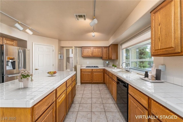 2104 Inverness Dr, Henderson, NV 89074 - kitchen featuring black appliances, track lighting, tile counters, and brown cabinets