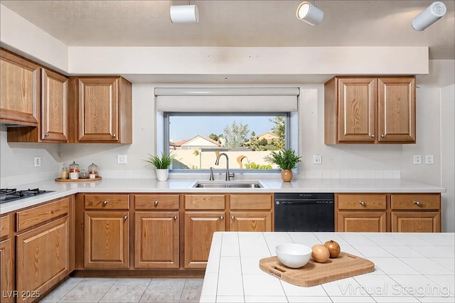 2104 Inverness Dr, Henderson, NV 89074 - kitchen featuring black dishwasher, stainless steel gas stovetop, light countertops, and brown cabinetry