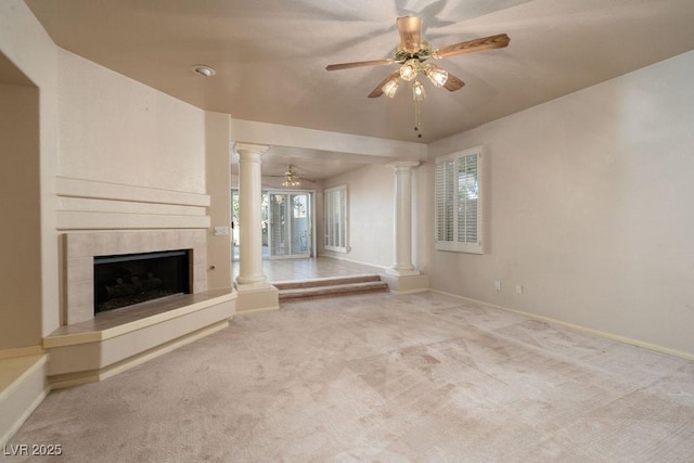 2104 Inverness Dr, Henderson, NV 89074 - unfurnished living room featuring decorative columns, a ceiling fan, a fireplace, and carpet flooring