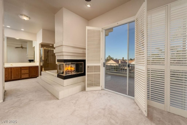 2104 Inverness Dr, Henderson, NV 89074 - living area featuring carpet, a multi sided fireplace, recessed lighting, and a ceiling fan