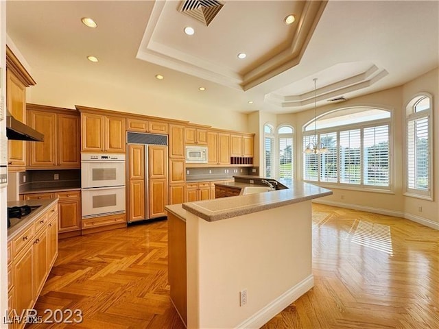 2017 Eagle Trace Way, Las Vegas, NV 89117 - kitchen featuring a tray ceiling, built in appliances, a sink, healthy amount of natural light, and recessed lighting