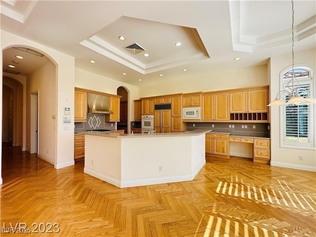 2017 Eagle Trace Way, Las Vegas, NV 89117 - kitchen with built in appliances, a raised ceiling, range hood, arched walkways, and tasteful backsplash