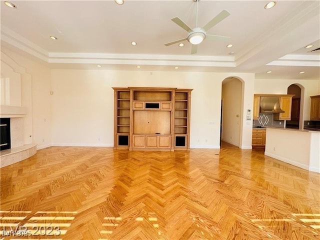 2017 Eagle Trace Way, Las Vegas, NV 89117 - unfurnished living room with arched walkways, a raised ceiling, a ceiling fan, baseboards, and recessed lighting