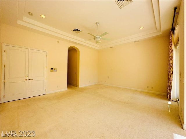 2017 Eagle Trace Way, Las Vegas, NV 89117 - unfurnished room featuring a raised ceiling, a ceiling fan, arched walkways, light colored carpet, and recessed lighting