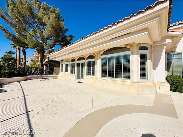 2017 Eagle Trace Way, Las Vegas, NV 89117 - rear view of property with a tiled roof, a patio, and stucco siding