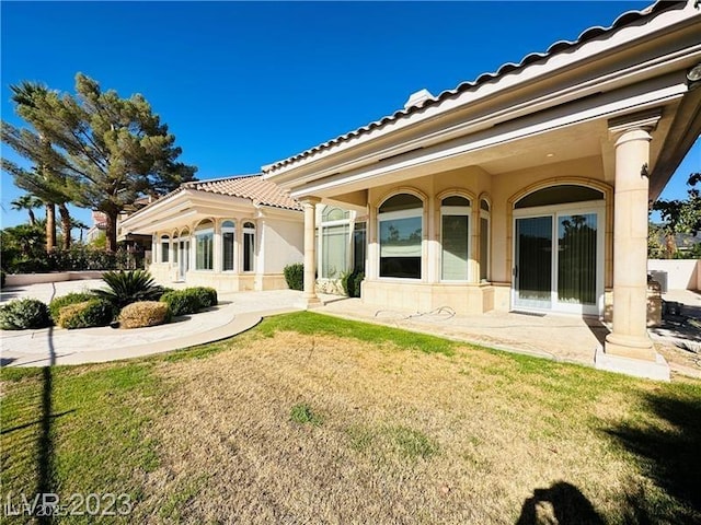 2017 Eagle Trace Way, Las Vegas, NV 89117 - back of house with a tiled roof, a yard, and a patio area