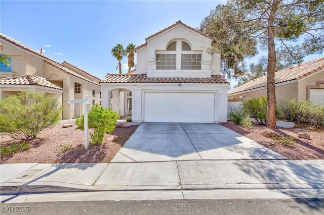 92 Sea Holly Way, Henderson, NV 89074 - mediterranean / spanish-style house featuring driveway, stucco siding, a tiled roof, and a garage