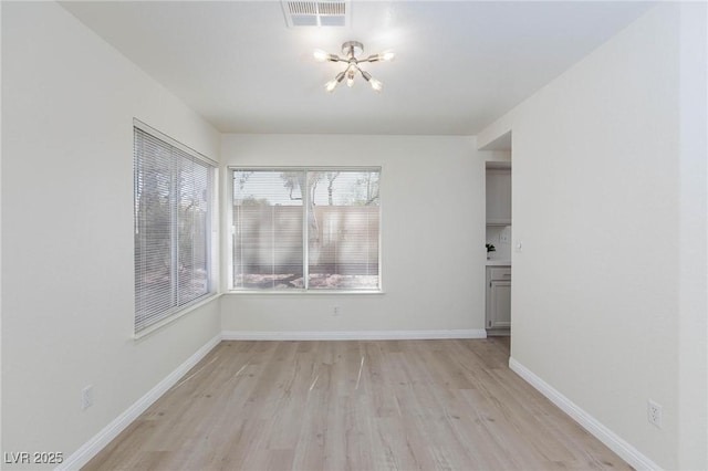 92 Sea Holly Way, Henderson, NV 89074 - empty room with a chandelier and light wood-type flooring