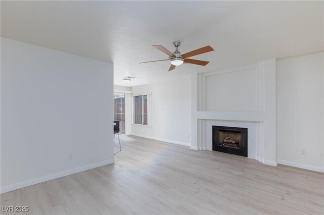 92 Sea Holly Way, Henderson, NV 89074 - unfurnished living room featuring a fireplace, ceiling fan, and wood finished floors