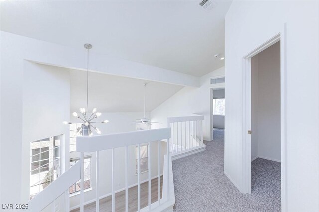 92 Sea Holly Way, Henderson, NV 89074 - hall featuring lofted ceiling, an upstairs landing, carpet floors, and a chandelier