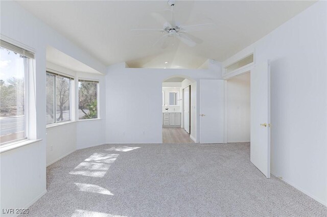 92 Sea Holly Way, Henderson, NV 89074 - unfurnished room featuring carpet floors, arched walkways, a ceiling fan, and lofted ceiling