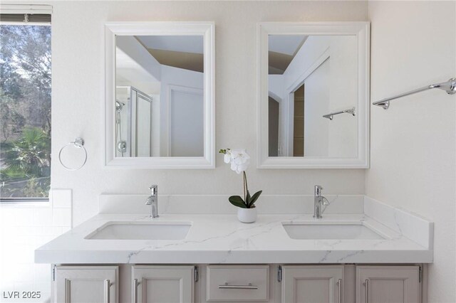 92 Sea Holly Way, Henderson, NV 89074 - bathroom featuring double vanity and a shower with shower door