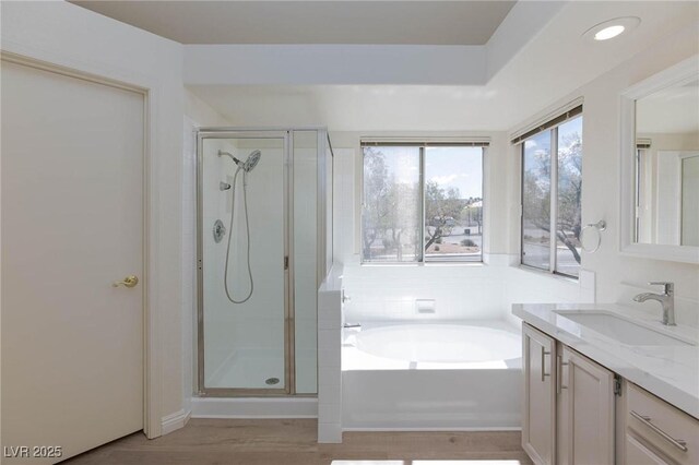 92 Sea Holly Way, Henderson, NV 89074 - full bathroom with vanity, a stall shower, a garden tub, wood finished floors, and recessed lighting