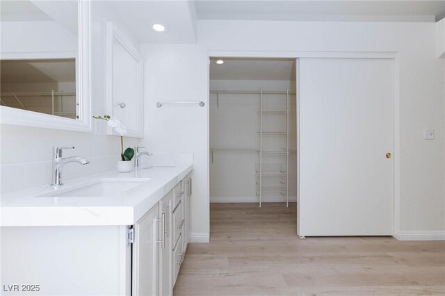 92 Sea Holly Way, Henderson, NV 89074 - bathroom featuring double vanity, wood finished floors, and recessed lighting