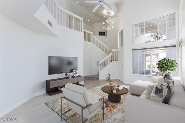 92 Sea Holly Way, Henderson, NV 89074 - living room with stairway, a towering ceiling, wood finished floors, and a ceiling fan