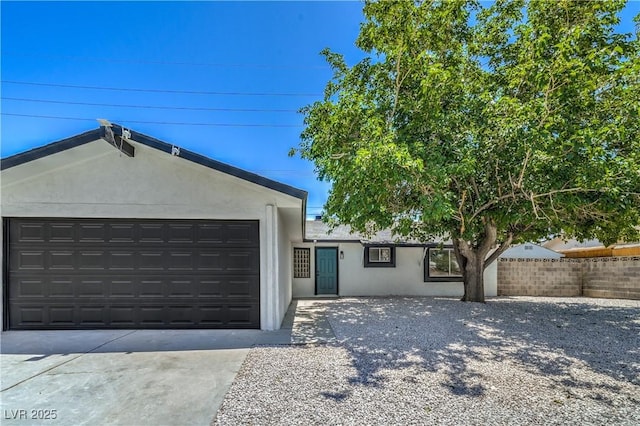 5279 Consul Ave, Las Vegas, NV 89142 - ranch-style house with stucco siding, concrete driveway, and an attached garage