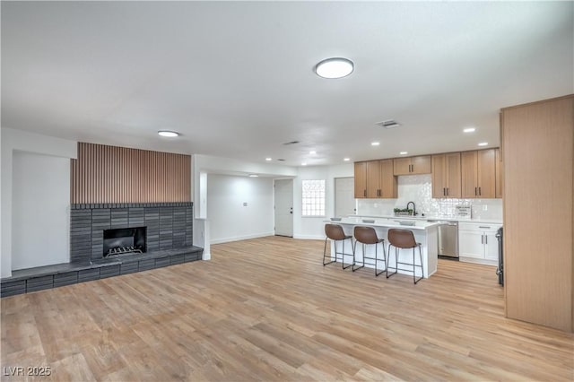 5279 Consul Ave, Las Vegas, NV 89142 - kitchen with open floor plan, dishwasher, light countertops, a breakfast bar, and a center island