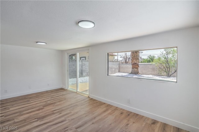 5279 Consul Ave, Las Vegas, NV 89142 - empty room featuring baseboards, wood finished floors, and a textured ceiling