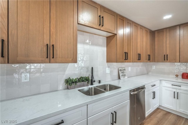5279 Consul Ave, Las Vegas, NV 89142 - kitchen featuring dishwasher, a sink, backsplash, white cabinetry, and light stone counters