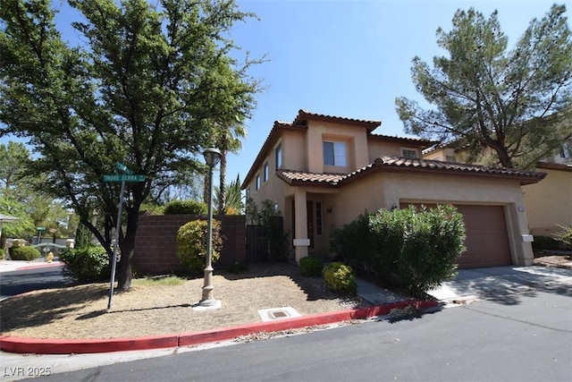 1220 Padre Serra Ln, Las Vegas, NV 89134 - mediterranean / spanish-style home with stucco siding, an attached garage, a tile roof, and driveway
