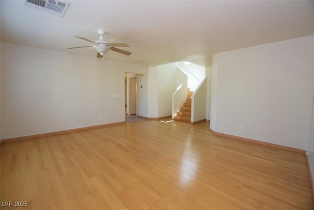 1220 Padre Serra Ln, Las Vegas, NV 89134 - empty room featuring a ceiling fan, light wood-style floors, stairs, and baseboards