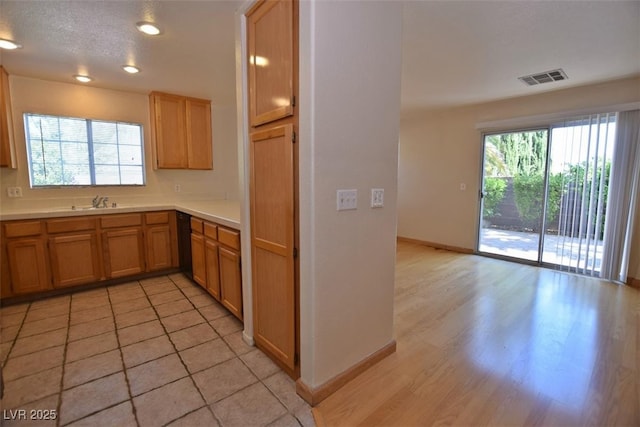 1220 Padre Serra Ln, Las Vegas, NV 89134 - kitchen featuring plenty of natural light, light countertops, baseboards, light wood-style flooring, and recessed lighting