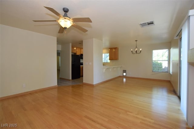 1220 Padre Serra Ln, Las Vegas, NV 89134 - unfurnished living room with a chandelier, light wood finished floors, ceiling fan, and baseboards
