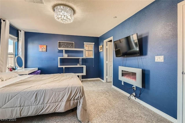 2806 Calle Cadiz, Henderson, NV 89044 - bedroom featuring carpet flooring, a chandelier, baseboards, and a glass covered fireplace