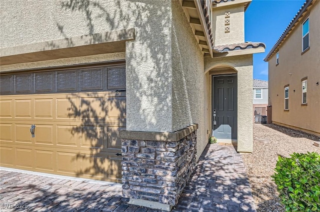 2806 Calle Cadiz, Henderson, NV 89044 - view of exterior entry featuring a garage, stucco siding, and a tiled roof