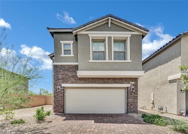 10345 Zebra Swallowtail St, Las Vegas, NV 89141 - view of front of home with decorative driveway, stucco siding, an attached garage, and stone siding