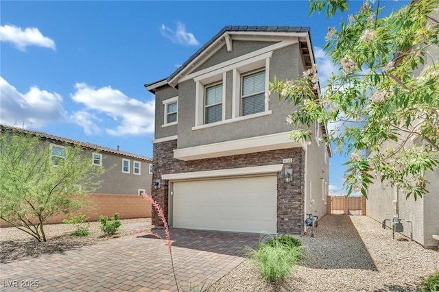10345 Zebra Swallowtail St, Las Vegas, NV 89141 - view of front of home with stucco siding, an attached garage, decorative driveway, and stone siding