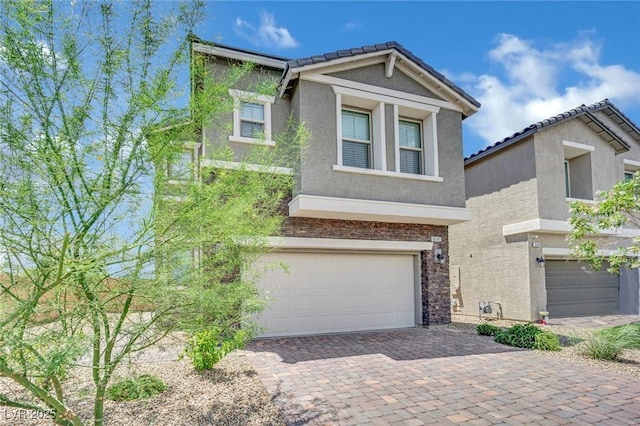 10345 Zebra Swallowtail St, Las Vegas, NV 89141 - view of front of house with a garage, stucco siding, driveway, and a tiled roof