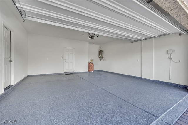 10345 Zebra Swallowtail St, Las Vegas, NV 89141 - garage featuring a garage door opener, water heater, and baseboards