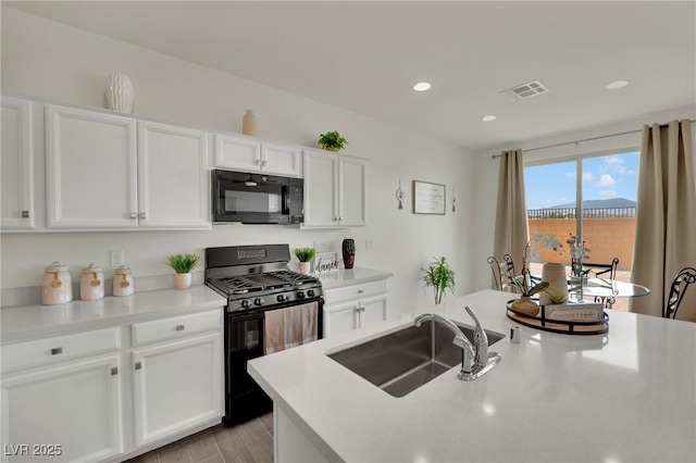 10345 Zebra Swallowtail St, Las Vegas, NV 89141 - kitchen with black appliances, a sink, white cabinets, recessed lighting, and light countertops